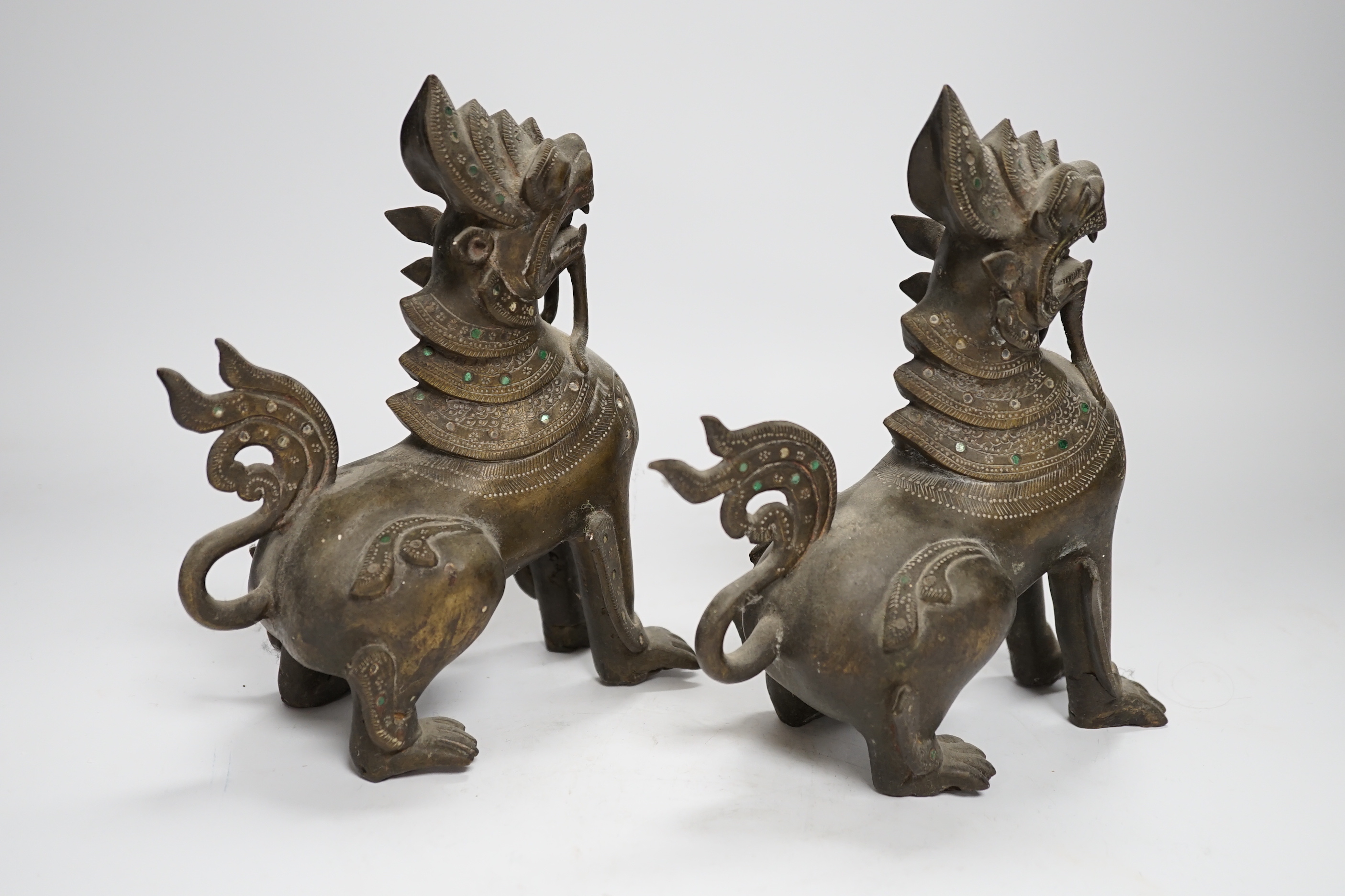 A pair of Thai bronze figures of lion dogs, 20cm